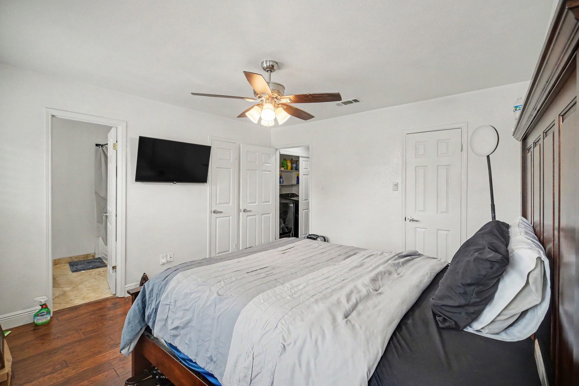 Cozy and inviting, this second bedroom offers ample space with modern comforts, featuring sleek hardwood floors, a convenient ceiling fan, and direct access to an ensuite bathroom.