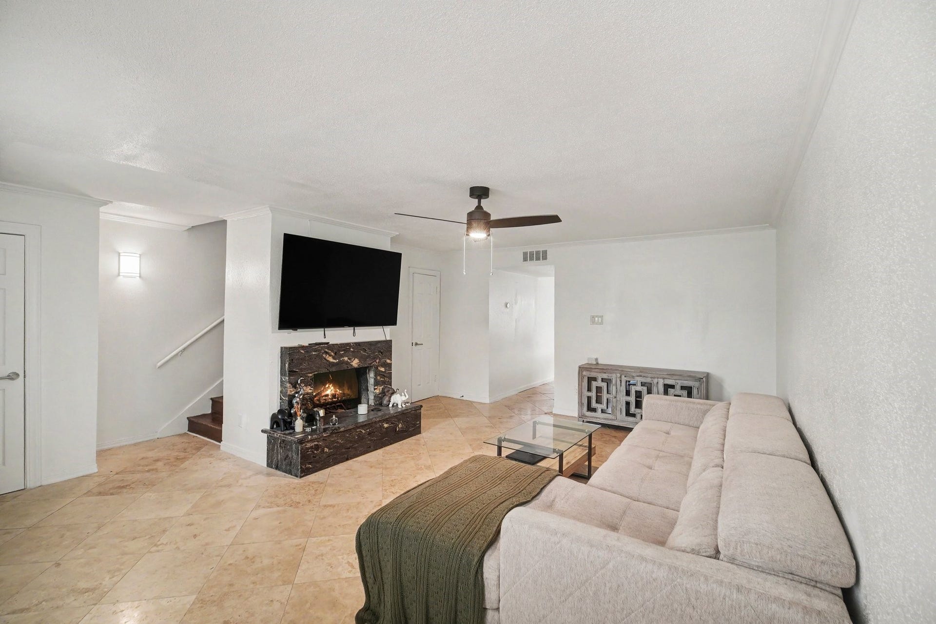 Cozy living area featuring a stylish fireplace, perfect for relaxing evenings and warm gatherings.