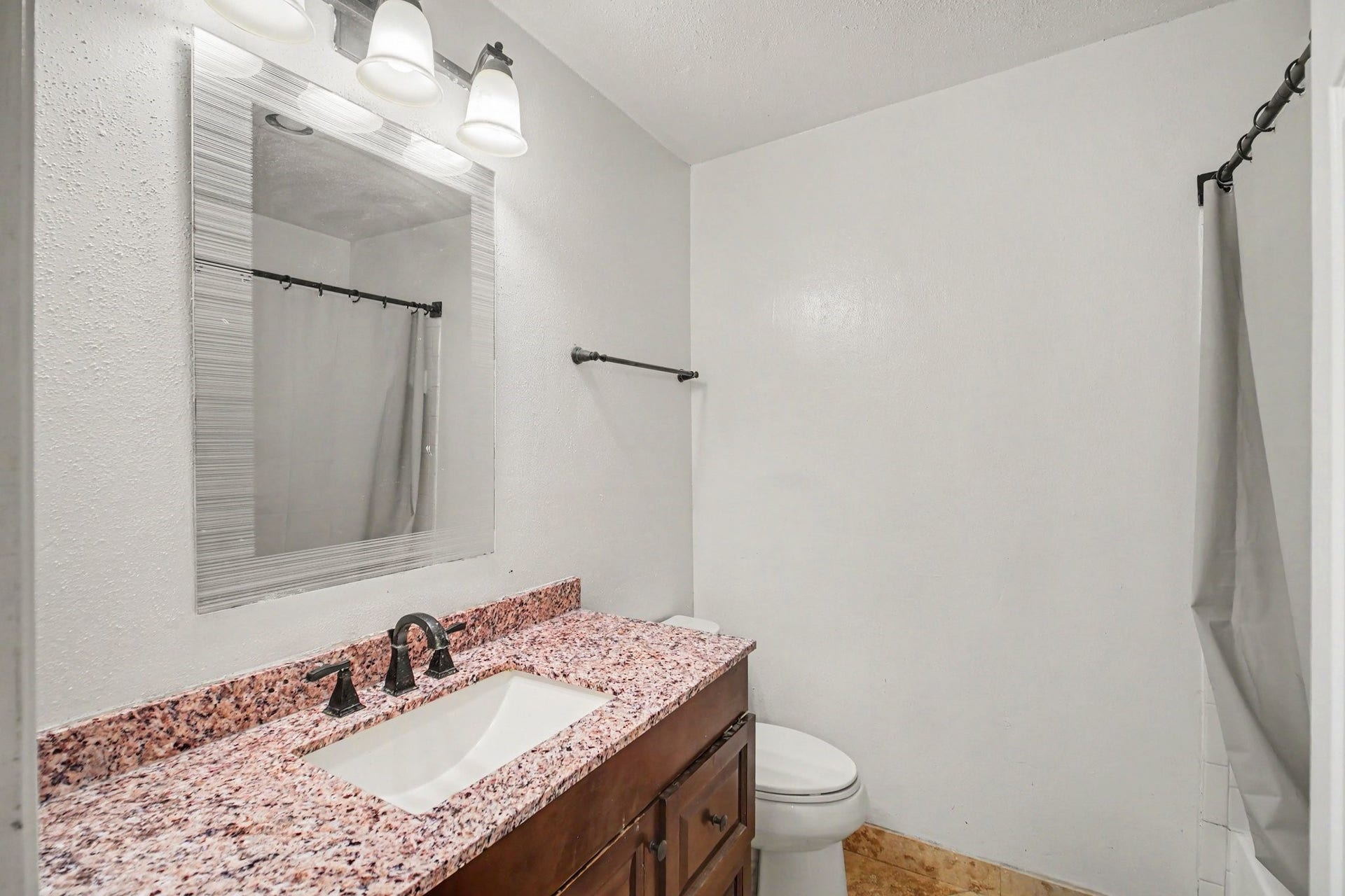 Experience modern comfort in this beautifully updated bath, featuring sleek fixtures and a stylish countertop that enhances your daily routine.