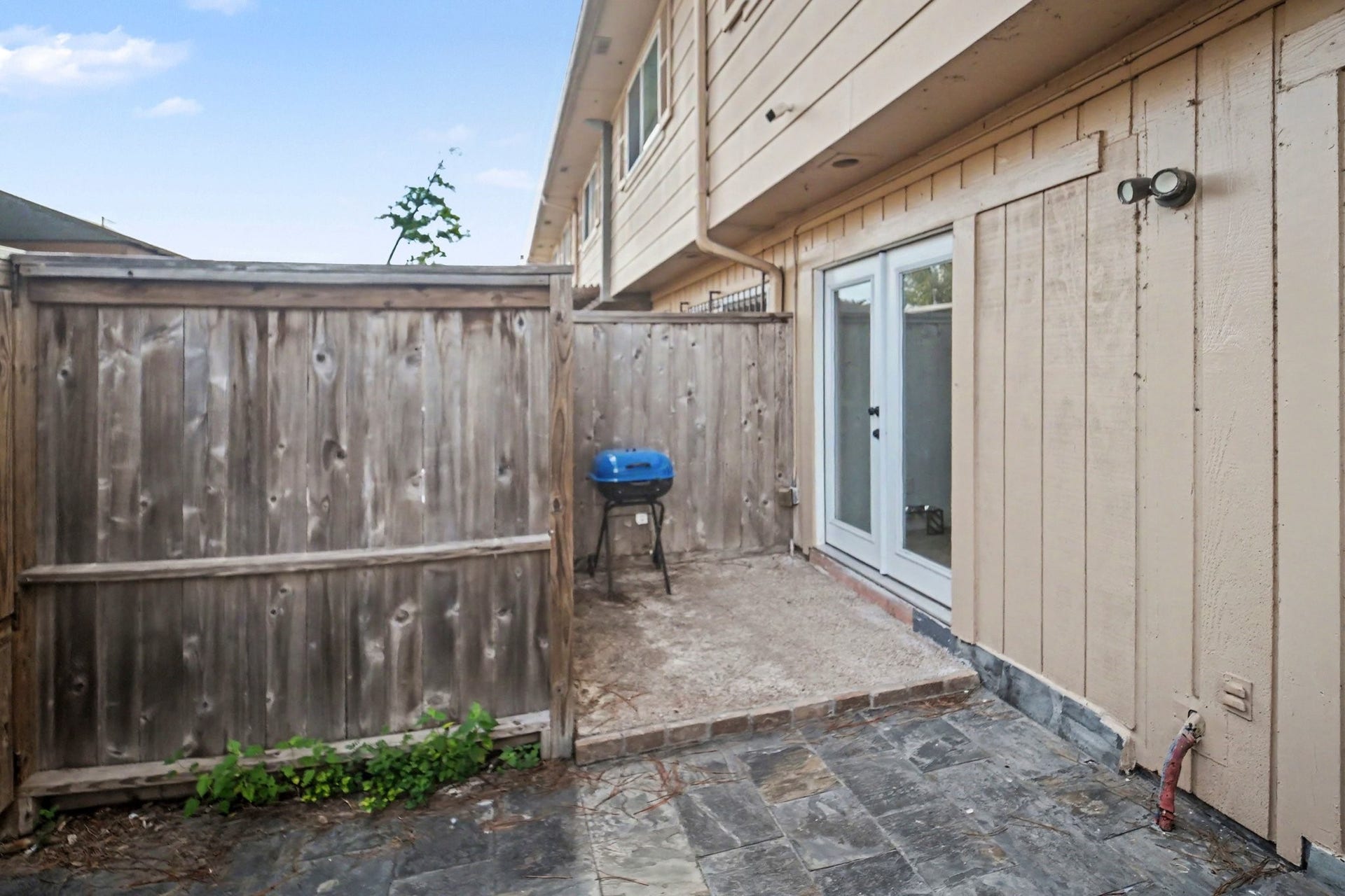 Discover a charming private patio perfect for intimate gatherings, seamlessly blending cozy outdoor living with privacy and style.