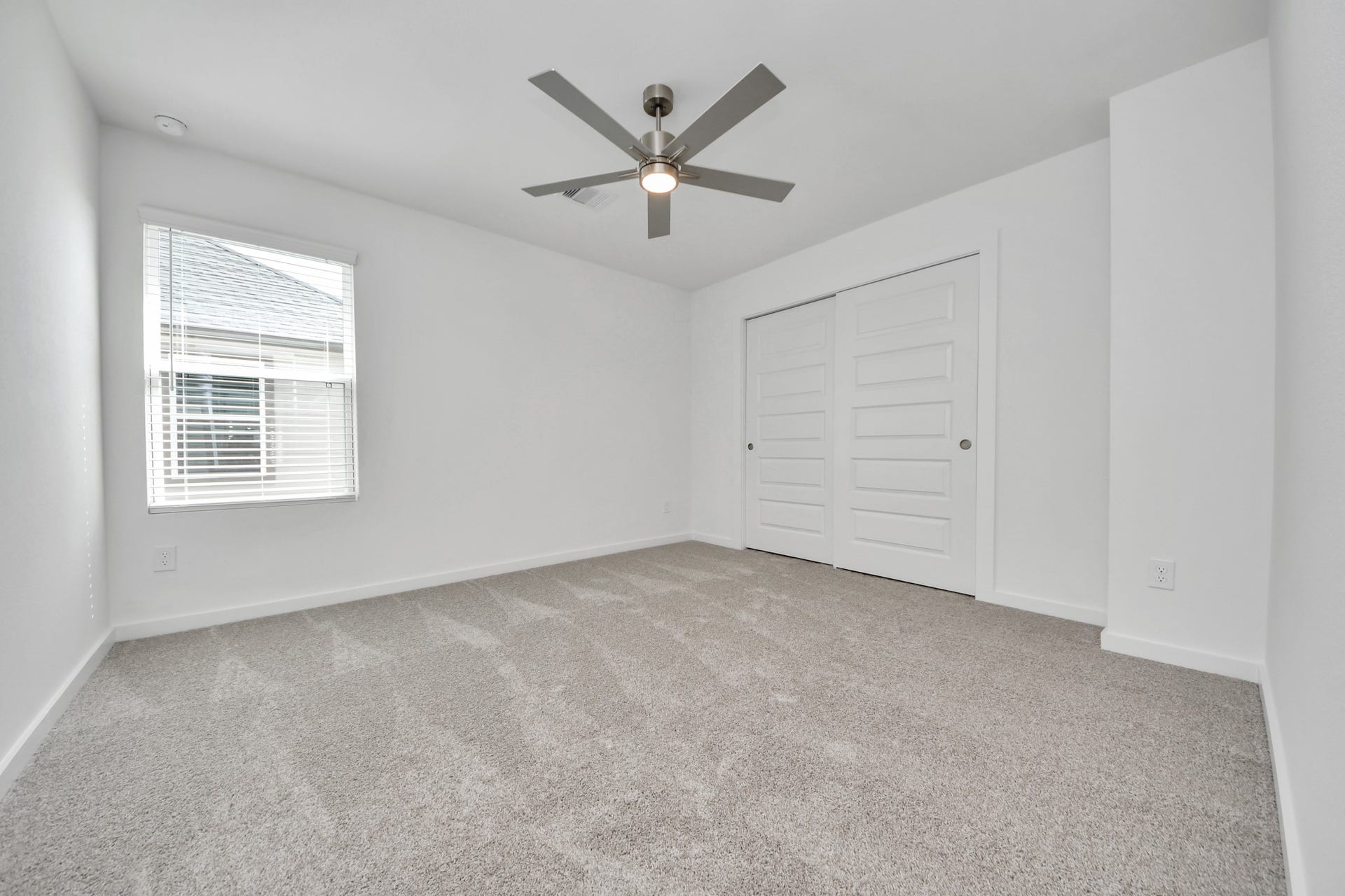 5818 Madison Trail Drive, Richmond, TX 77469 Secondary bedroom features plush carpeting, large windows that let in plenty of natural light, bright paint, and spacious closets. Sample photo of completed home with similar floor plan. Actual colors and selections may vary.