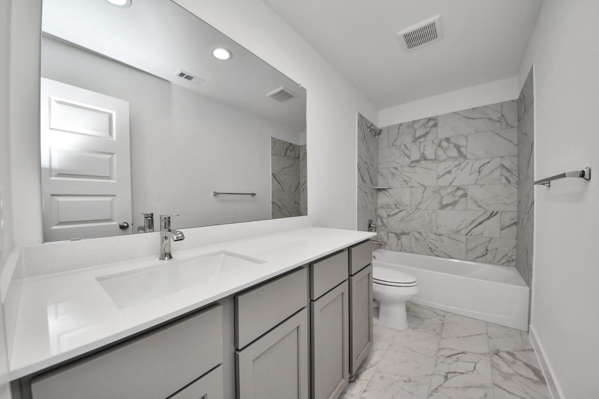 5818 Madison Trail Drive, Richmond, TX 77469 Secondary bedroom features plush carpeting, large windows that let in plenty of natural light, bright paint, and spacious closets. Sample photo of completed home with similar floor plan. Actual colors and selections may vary.
