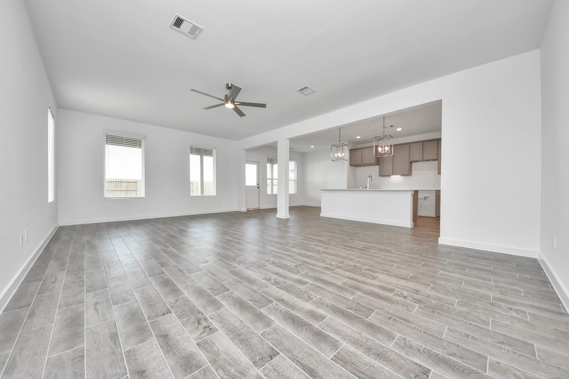 5818 Madison Trail Drive, Richmond, TX 77469 Relax and unwind in this inviting family room, illuminated by abundant natural light streaming in through tall windows, complemented by high ceilings and stunning flooring. Stay comfortable year-round with the gentle breeze from the ceiling fan, creating the perfect atmosphere for family gatherings. Sample photo of completed home with similar floor plan. Actual colors and selections may vary.