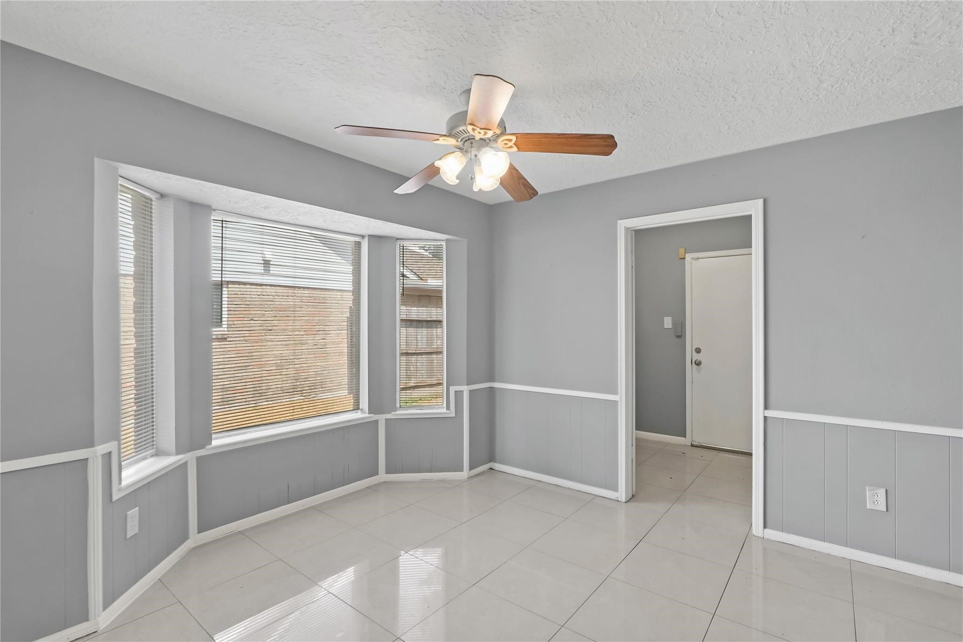 Just off the living area, is the bright breakfast area with bay windows offering plenty of natural light and access to the utility room, which leads to the backyard.
