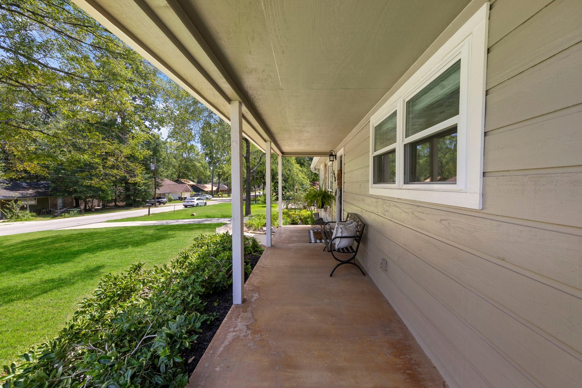 Relax and unwind on the expansive covered front porch, offering the perfect place to enjoy your morning coffee, greet neighbors, or take in the peaceful, tree-lined surroundings.