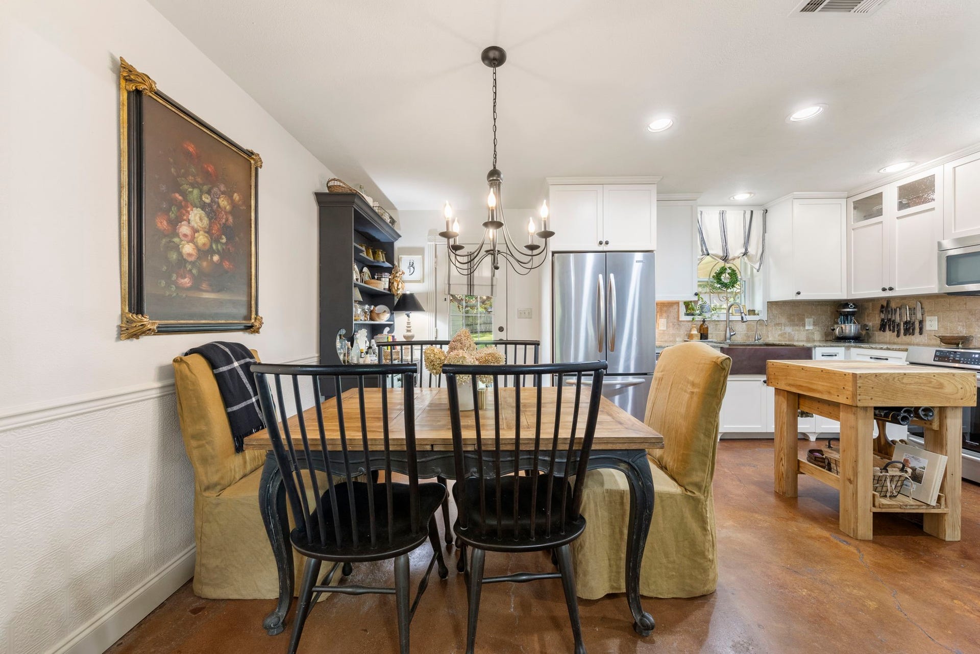 The dining area offers an inviting space for everyday meals and special gatherings, seamlessly connecting to the kitchen to create an effortless flow for entertaining and daily living.