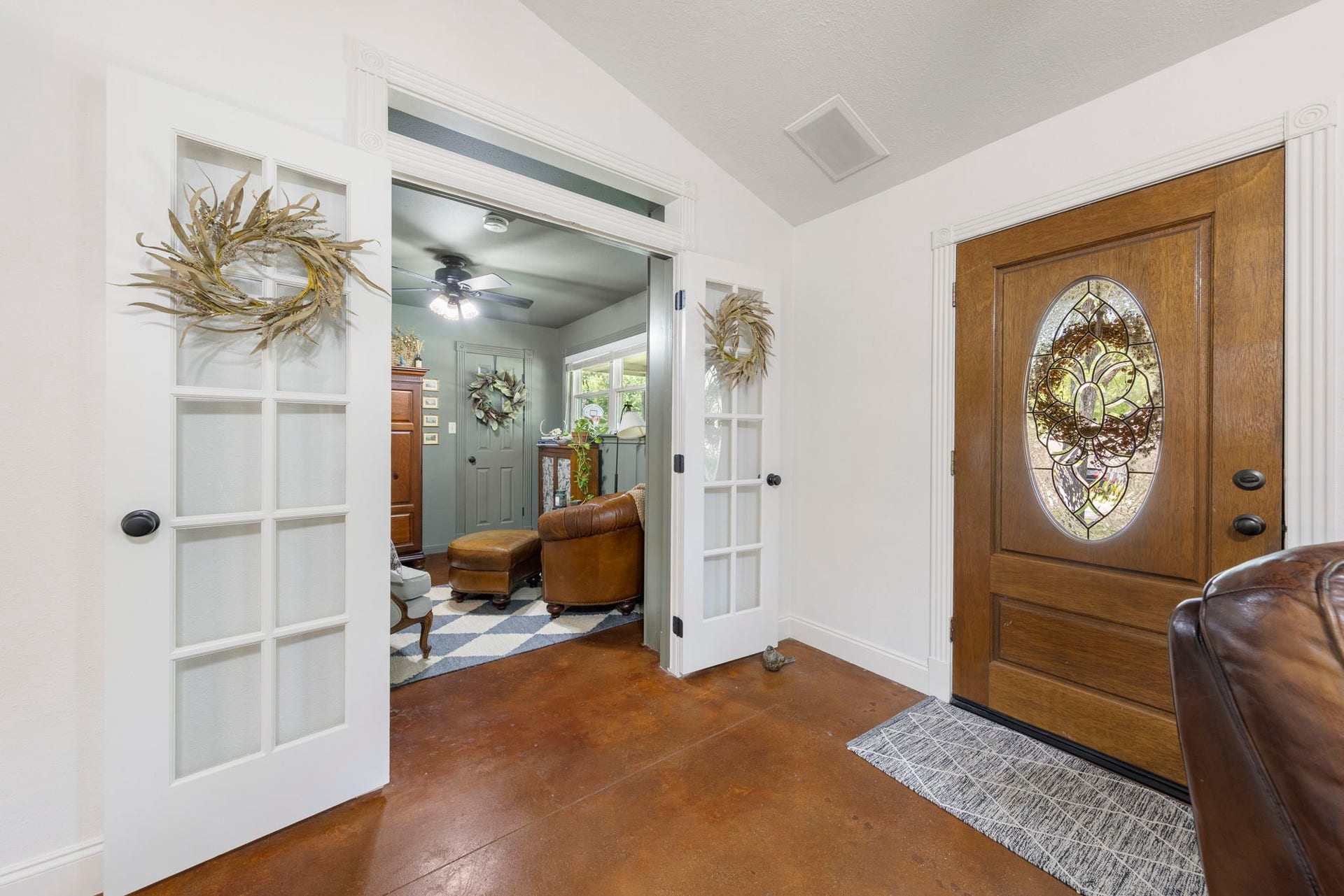 Elegant French doors leading to a private study, creating a flexible space ideal for a home office, library, or quiet retreat while adding timeless architectural character.