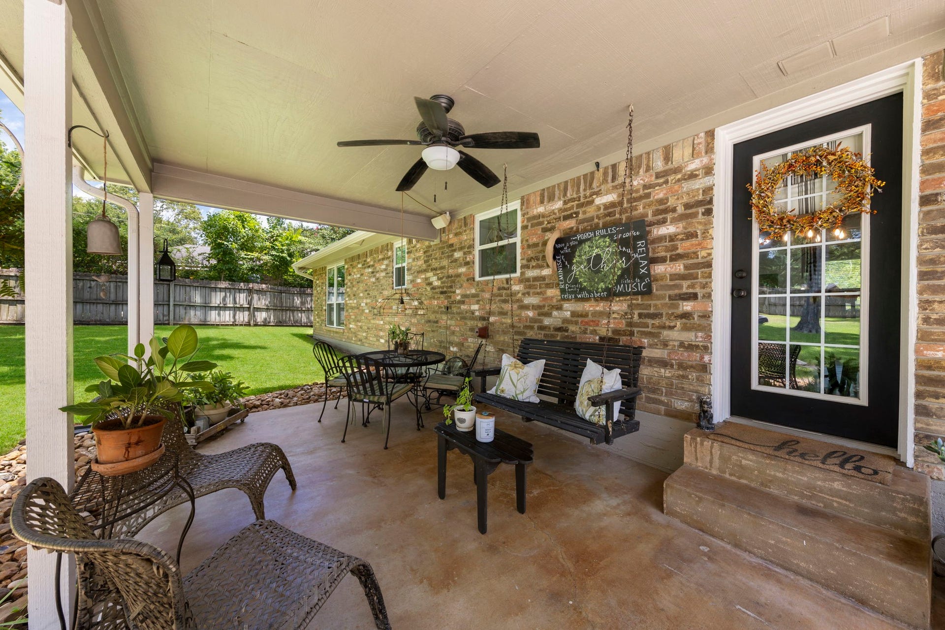 Enjoy seamless indoor-outdoor living from the covered back porch, complete with a ceiling fan, porch swing, and relaxing seating area overlooking the expansive, tree-shaded backyardan inviting space for morning coffee, evening gatherings, or quiet moments outdoors.