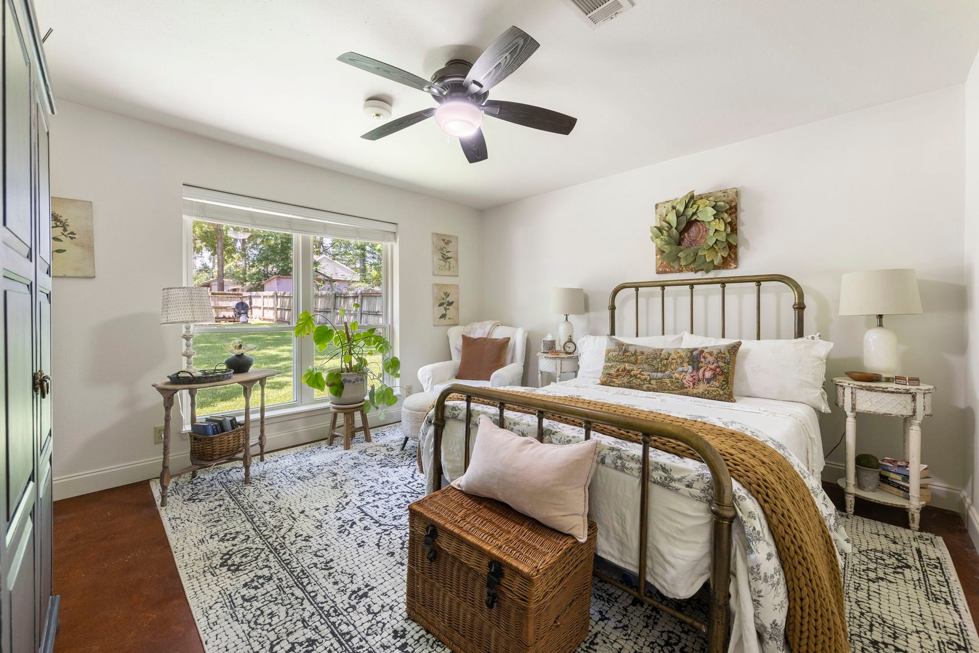 This spacious secondary bedroom offers generous natural light, peaceful backyard views, and ample room for family or guests, creating a comfortable and inviting retreat.