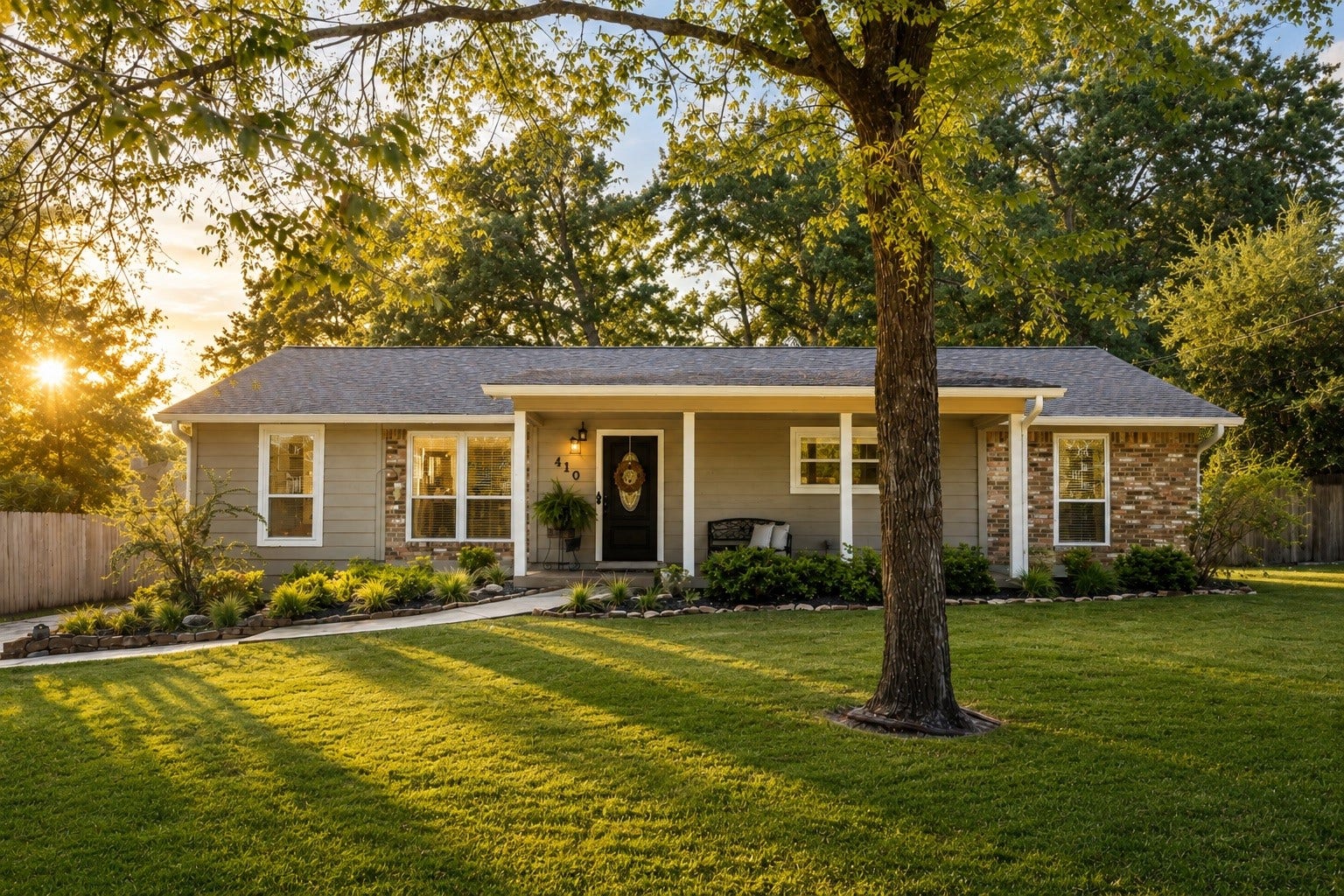 Nestled beneath mature shade trees on an oversized homesite, this beautifully maintained home welcomes you with timeless curb appeal, lush landscaping, and a charming covered front porch.