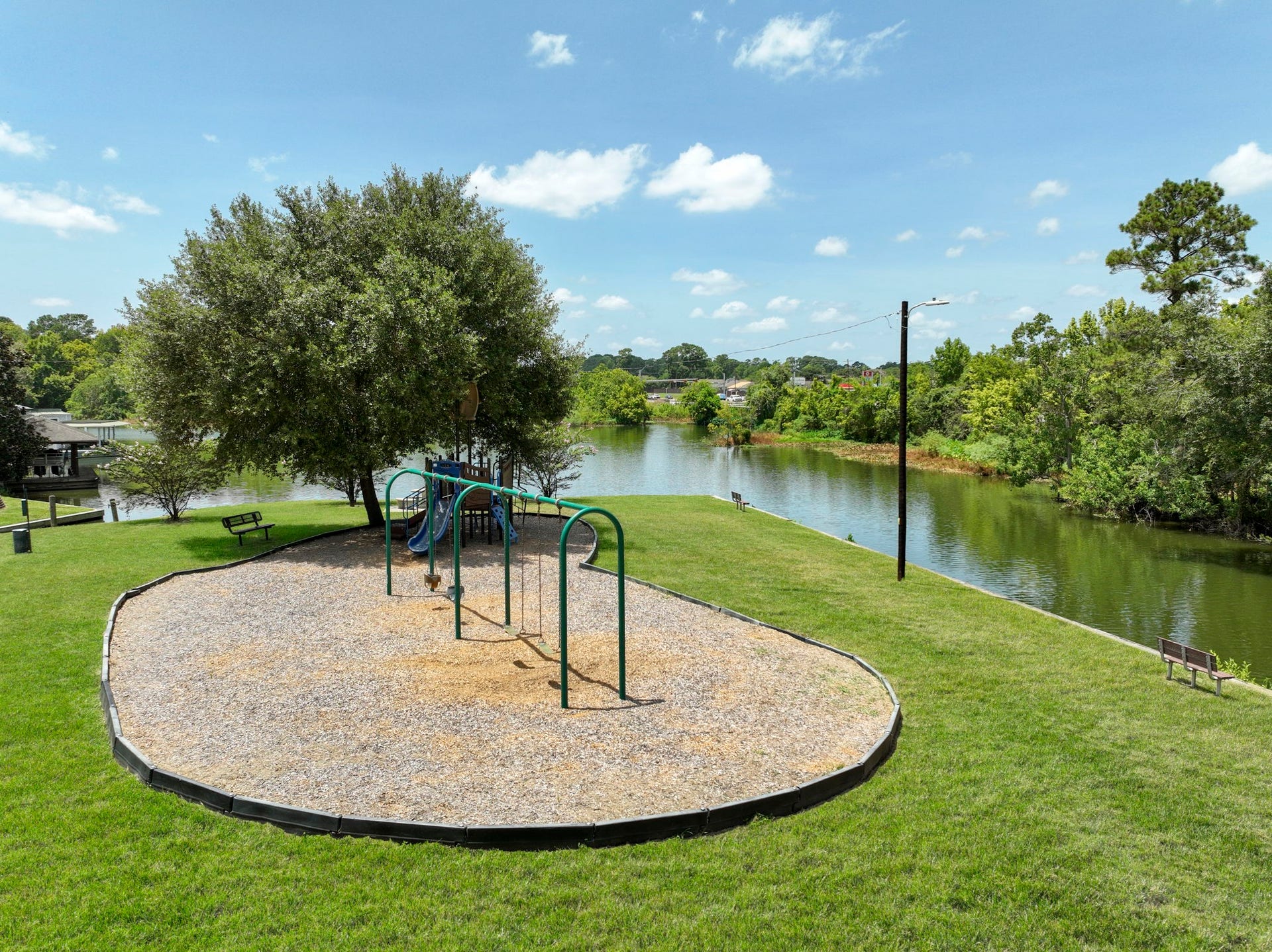 Residents enjoy a scenic waterfront park on Lake Conroe featuring a playground, picnic areas, and open green spaceperfect for spending time outdoors with family and friends while taking in beautiful lake views.