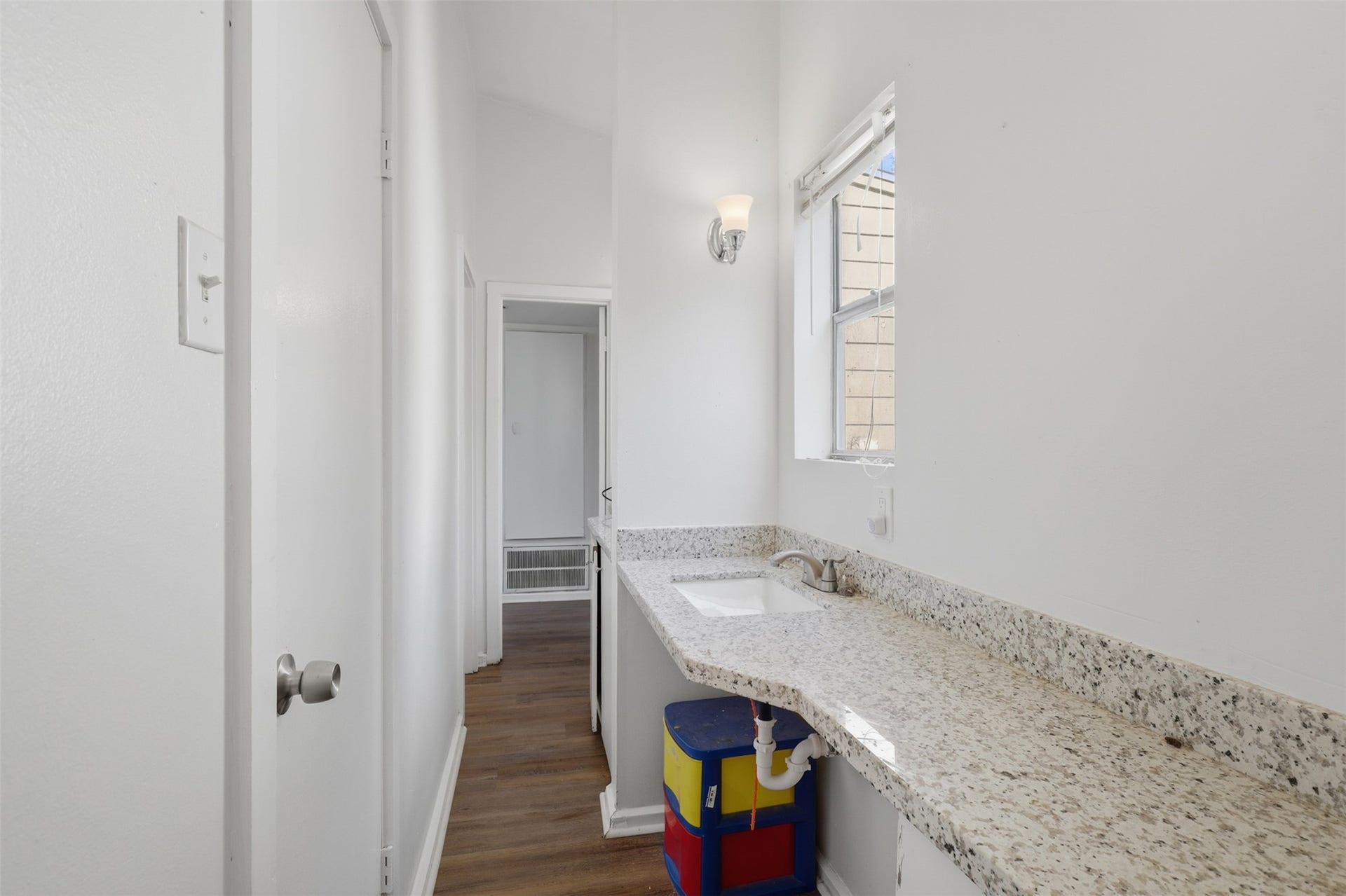 Expansive granite-look counter offers generous prep space and natural light, tucked conveniently near the upper-level hall.