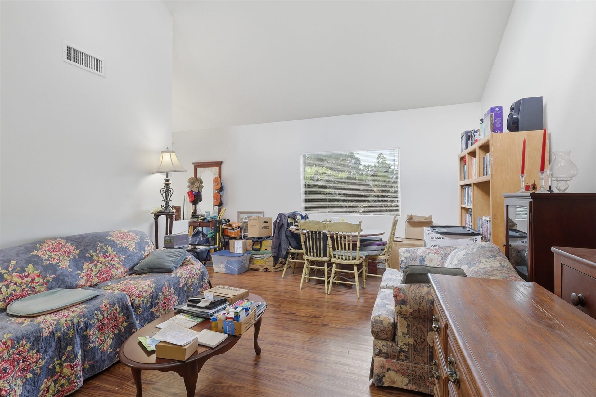 Warm hardwood-style floors stretch across an expansive interior layout, giving buyers a blank canvas to bring their dream living room to life.