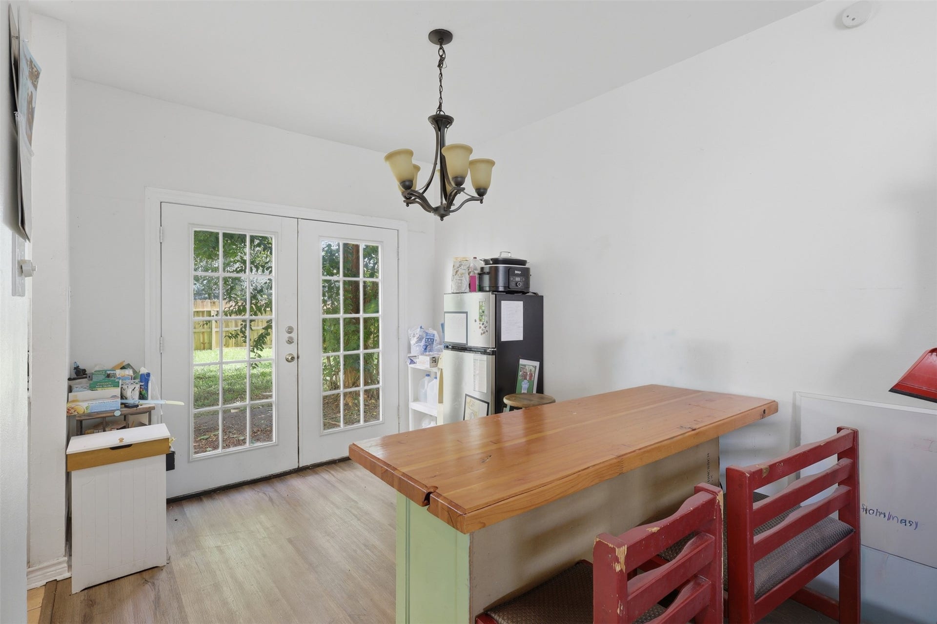 Charming French doors open directly onto the back lawn, creating a bright, breezy setting for relaxed meals and casual gatherings.