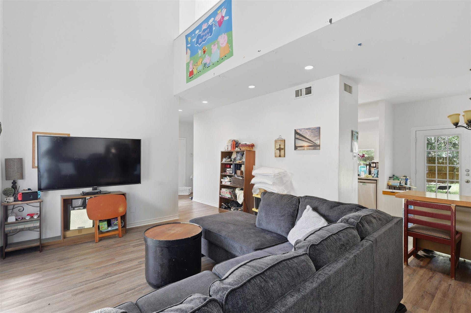 A spacious main floor anchor designed for effortless entertaining, seamlessly connecting cozy media seating directly to the kitchen and dining flow.