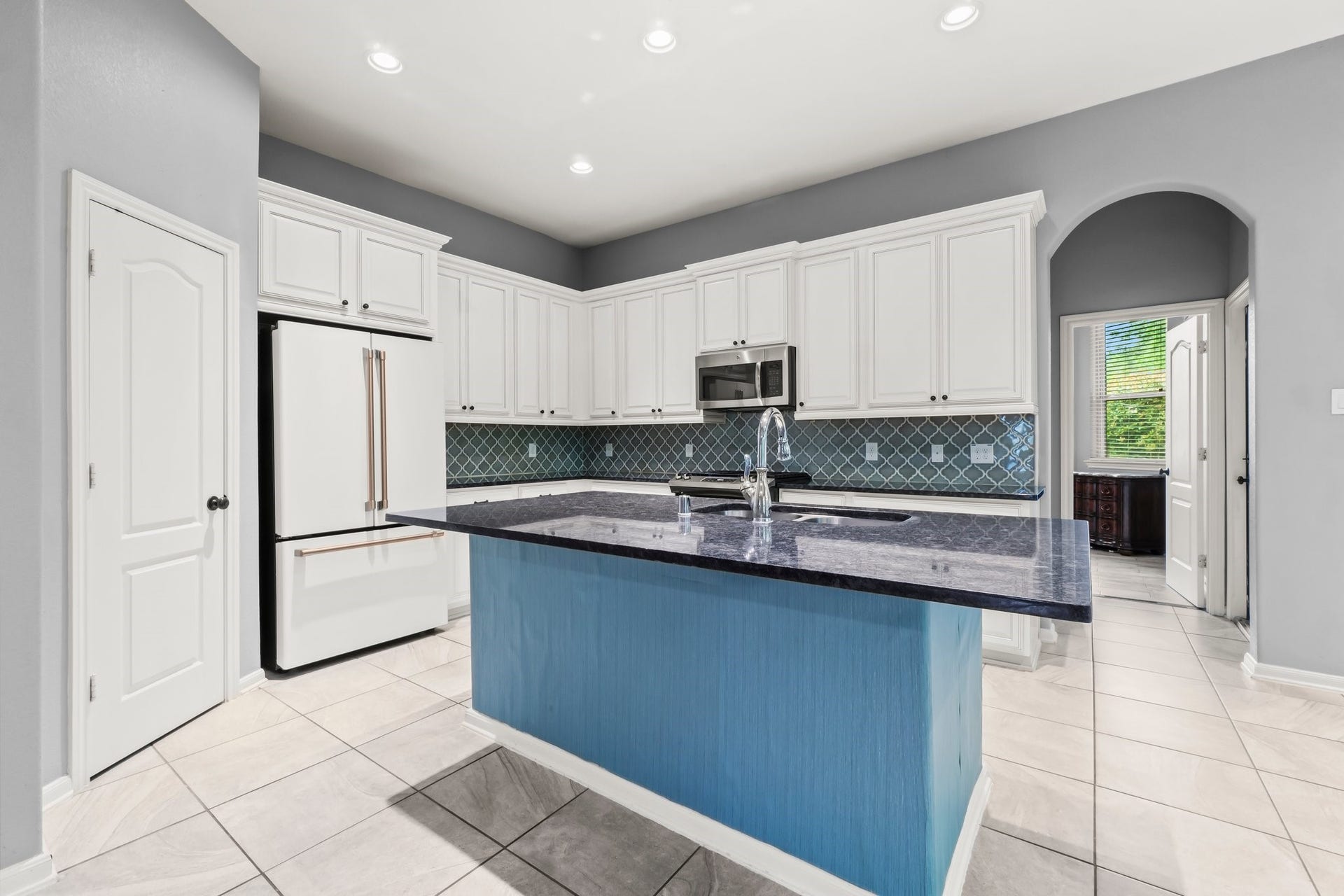 The kitchen features a spacious island and opens seamlessly to the living room.