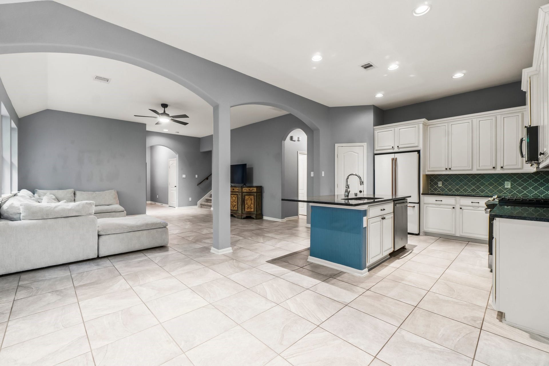 The living room seamlessly opens to the kitchen, creating the perfect space for entertaining.