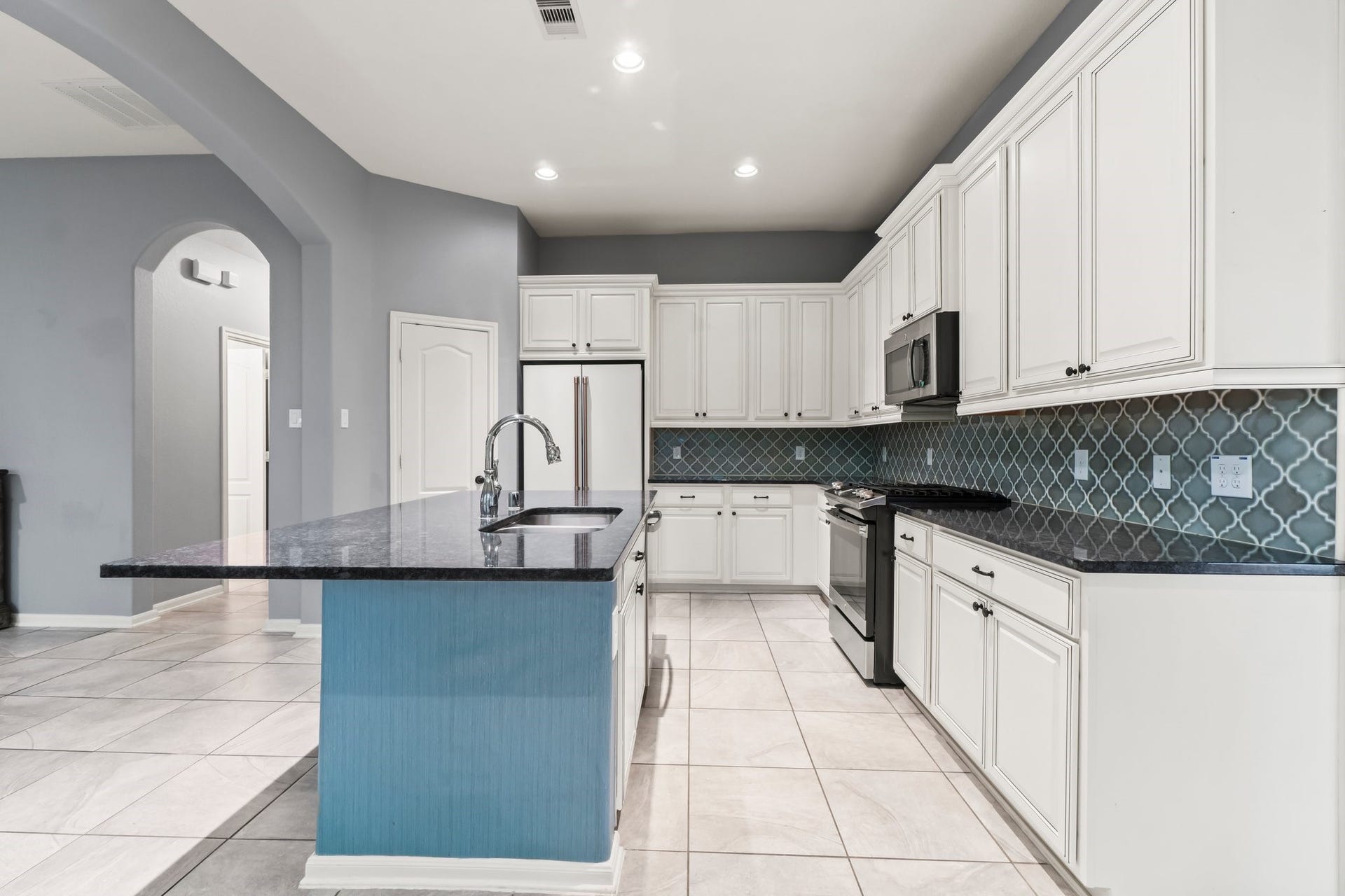 The kitchen features a spacious island and opens seamlessly to the living room.