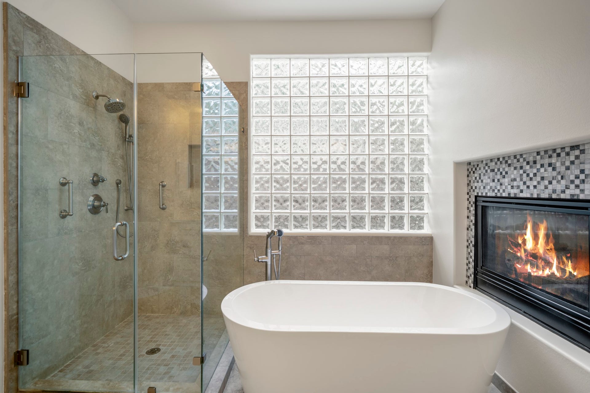 863 Plainwood Drive, Houston, TX 77079 A fireplace beside the soaking tub gives the primary bathroom a distinctive, retreat-like atmosphere.