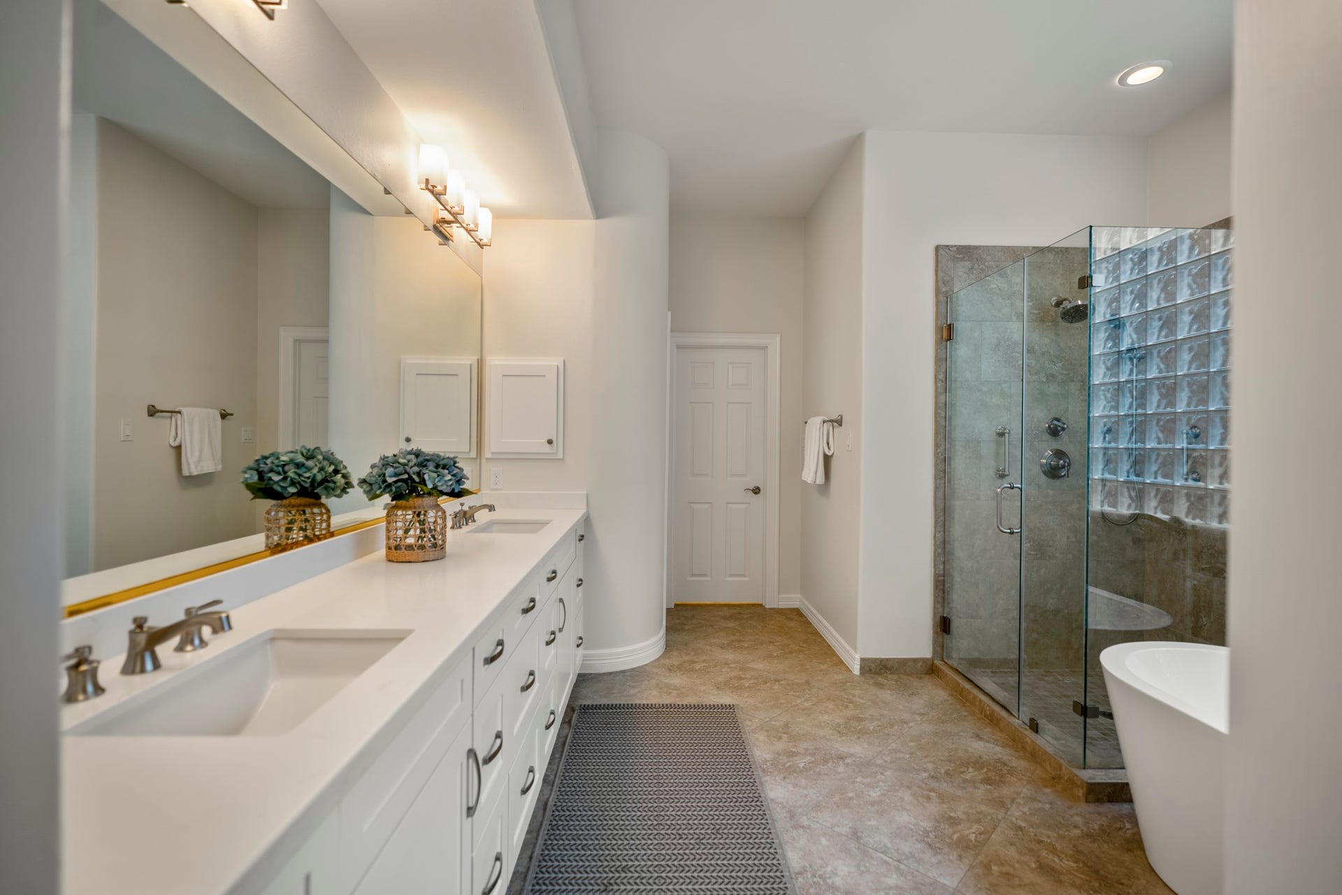 863 Plainwood Drive, Houston, TX 77079 The glass-block wall introduces diffused natural light while maintaining privacy.