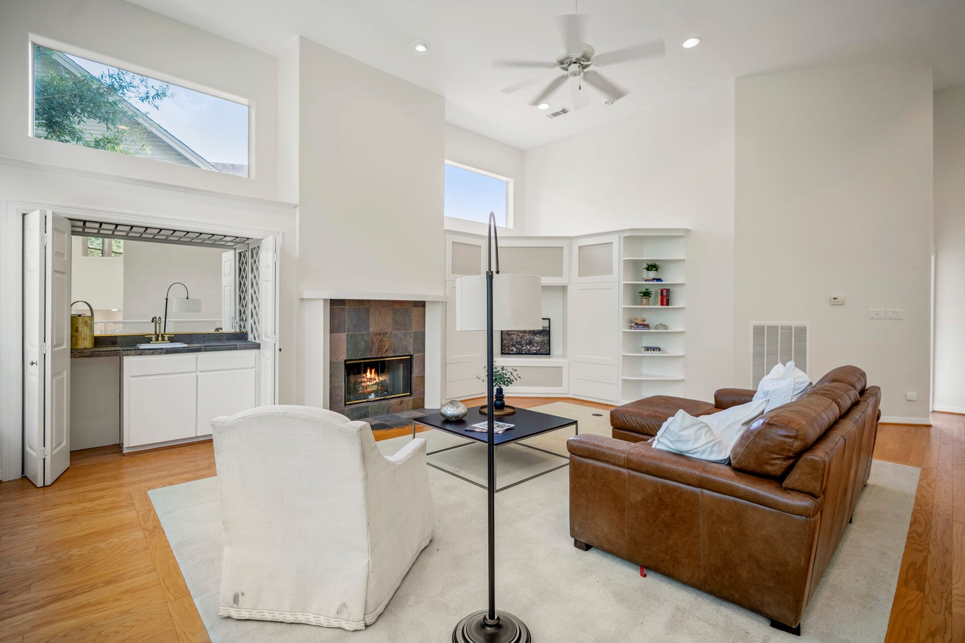 863 Plainwood Drive, Houston, TX 77079 A fireplace and custom built-ins create a warm focal point within the spacious living area.