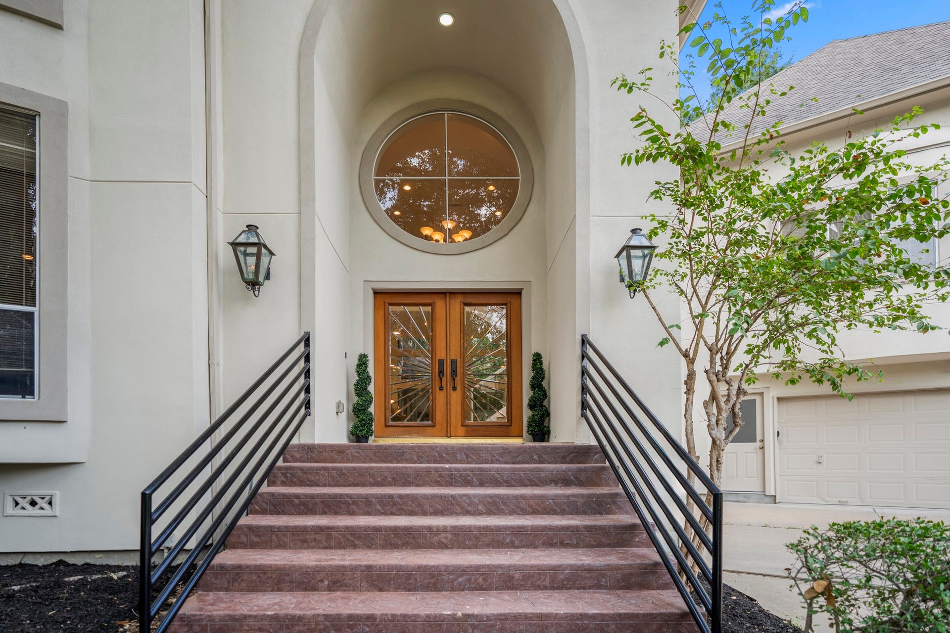 863 Plainwood Drive, Houston, TX 77079 Dramatic windows and a circular architectural accent give the home distinctive curb appeal.