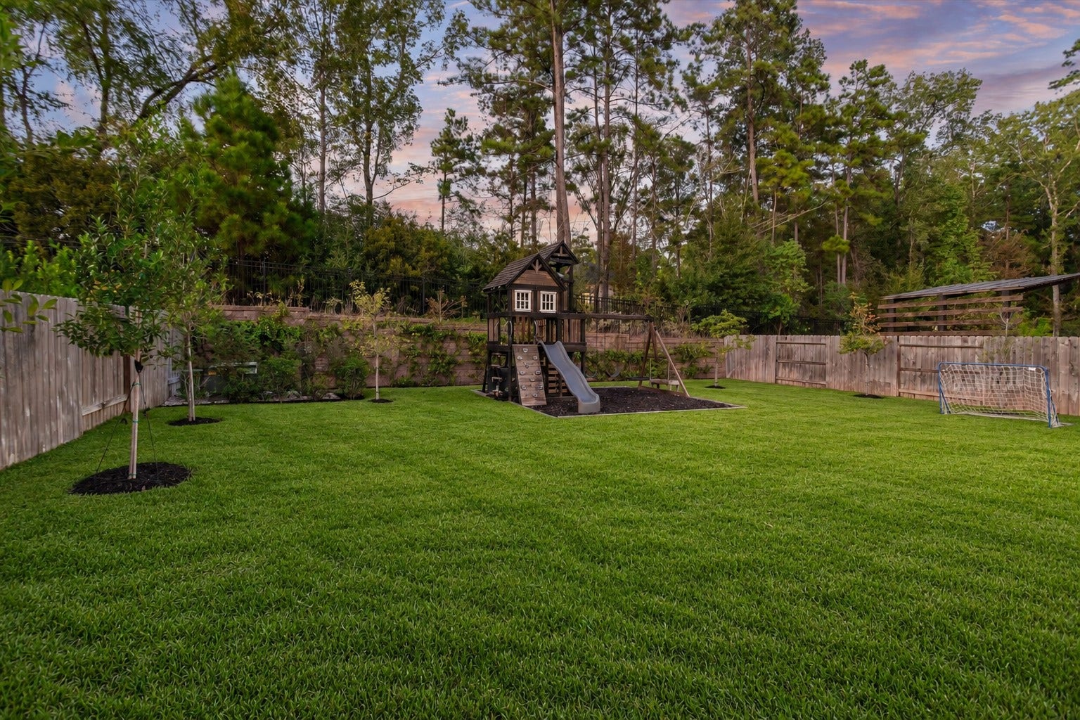 229 Patina Sorrel Drive, Montgomery, TX 77316 Experience ultimate privacy with no rear neighbors! A beautiful stone wall accented by elegant iron fencing frames the backyard, backing to lush, mature trees for a serene and secluded retreat.