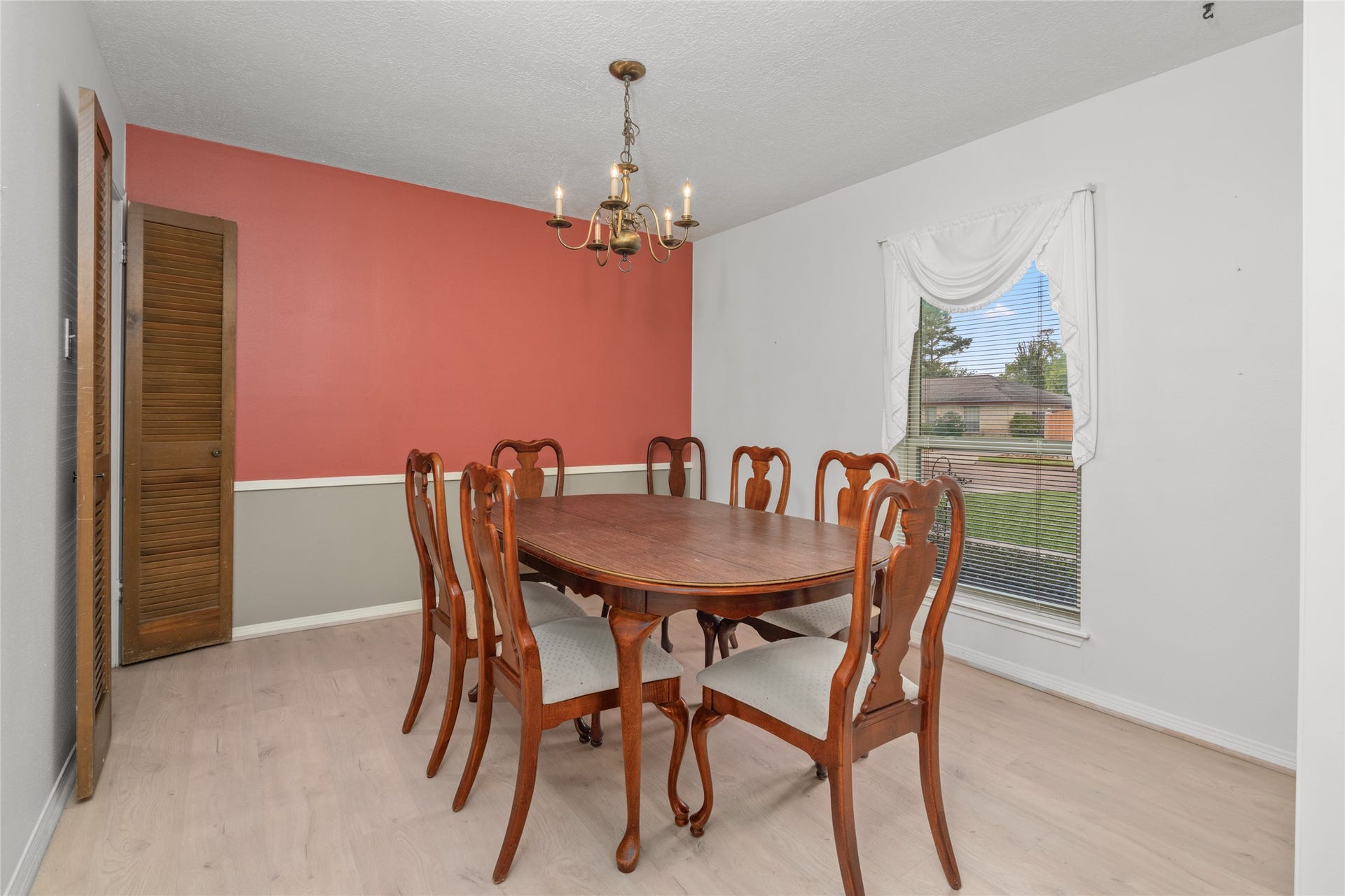 7015 Rosebrook Circle, Spring, TX 77379 Elegant formal dining room highlights include durable luxury vinyl plank flooring and an updated window with a view.