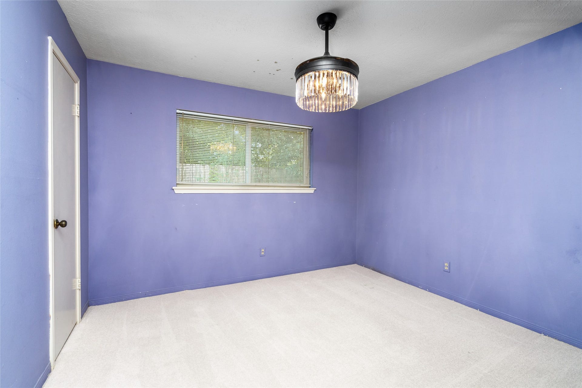7015 Rosebrook Circle, Spring, TX 77379 Bright third bedroom suite showcases an updated window, soft carpet, and a stylish light fixture.