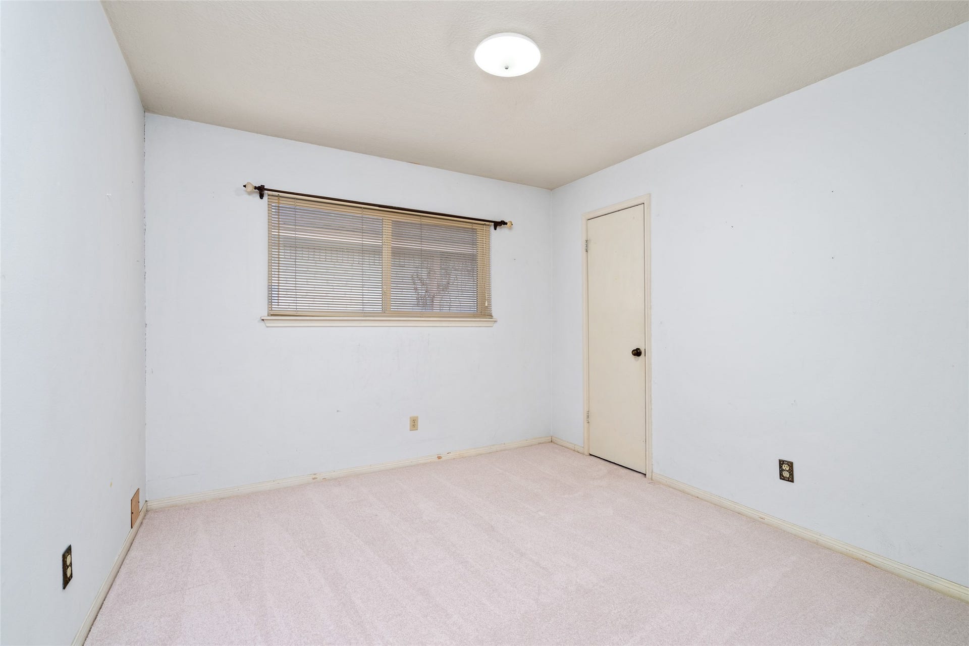 7015 Rosebrook Circle, Spring, TX 77379 Comfortable secondary bedroom features soft carpeting, neutral paint, and ample closet space.