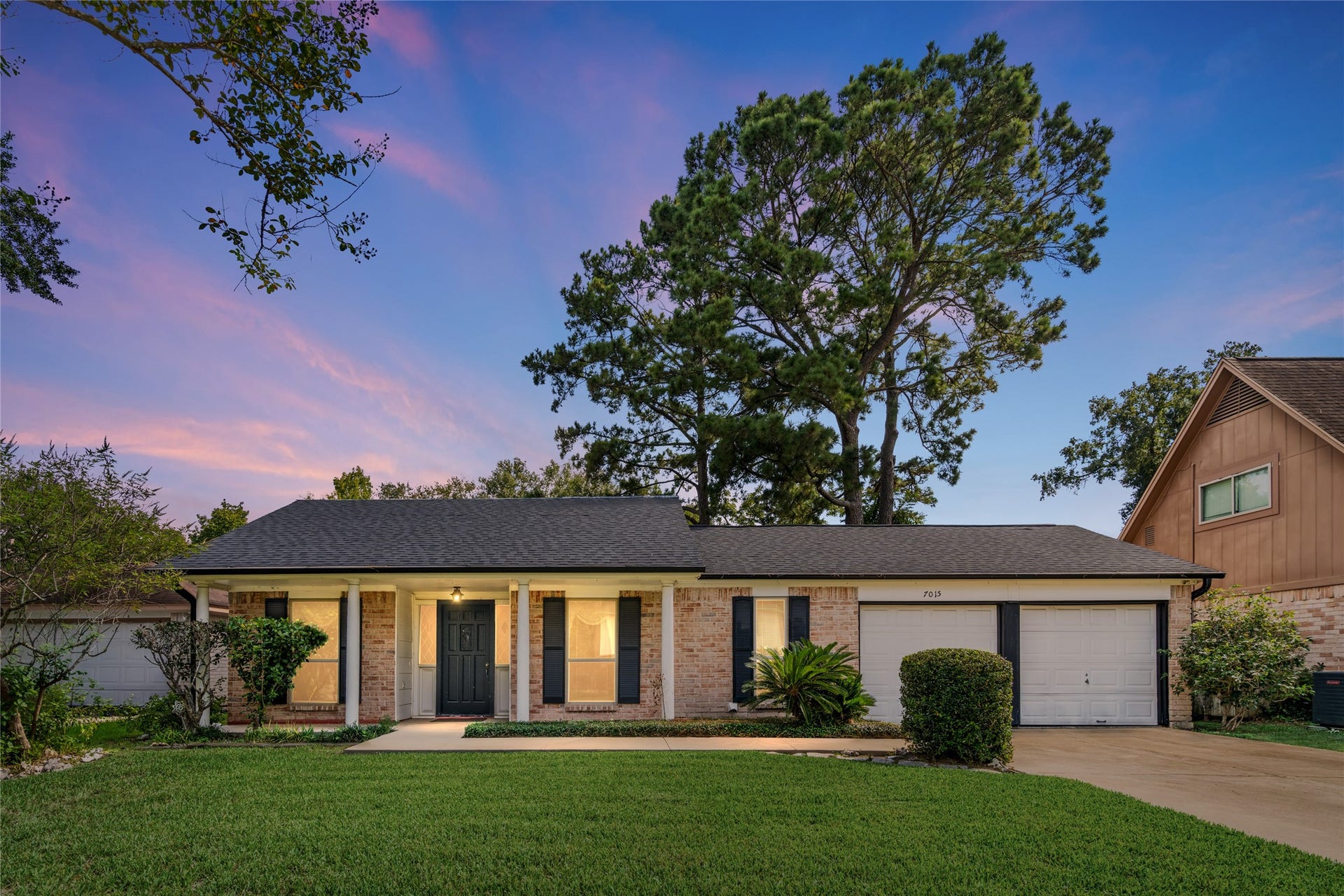 7015 Rosebrook Circle, Spring, TX 77379 Timeless brick curb appeal at twilight! Welcome home to a mature landscape framed by towering trees.