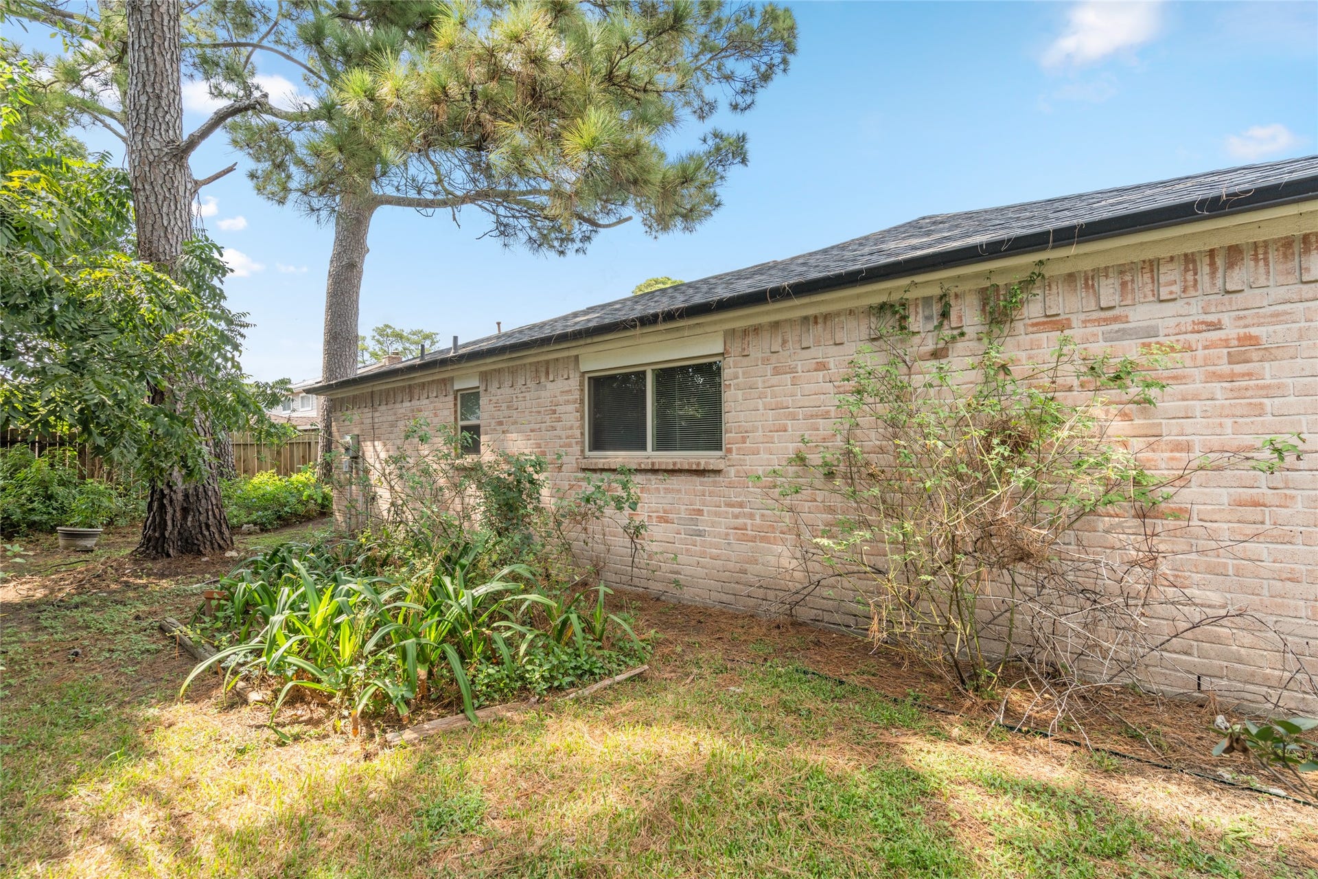 7015 Rosebrook Circle, Spring, TX 77379 Quiet mature backyard setting showcases low-maintenance Hardie siding, full gutters, and shade trees.