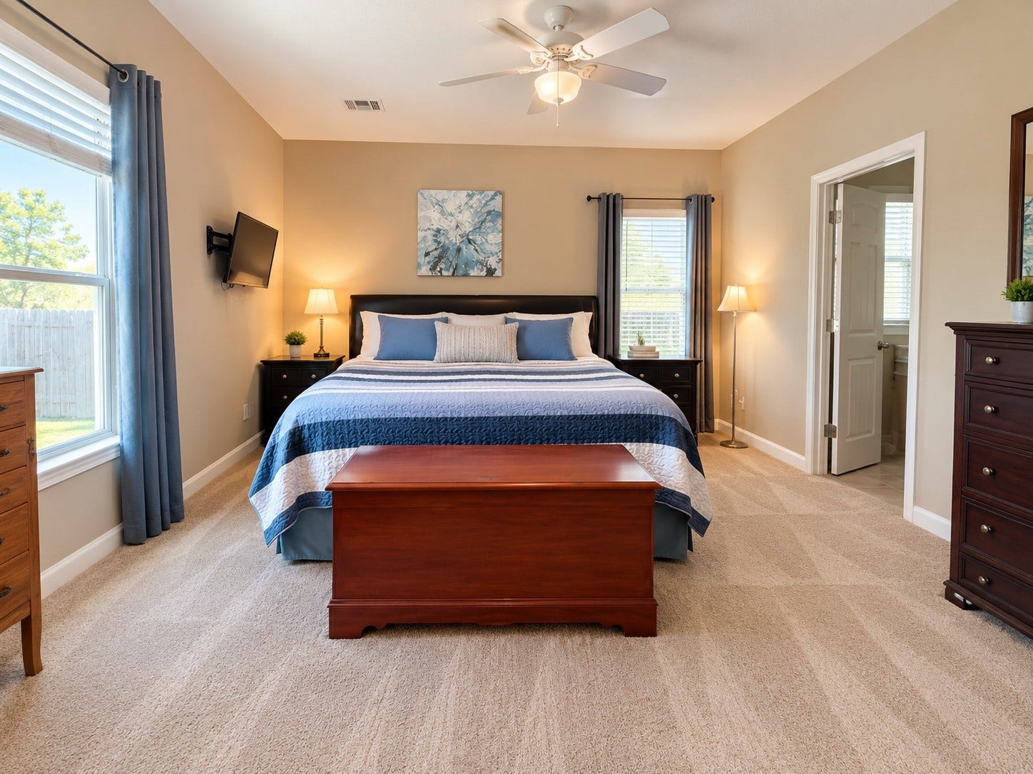 Conveniently located downstairs, the primary bedroom features a spacious en-suite bathroom and generous walk-in closet.