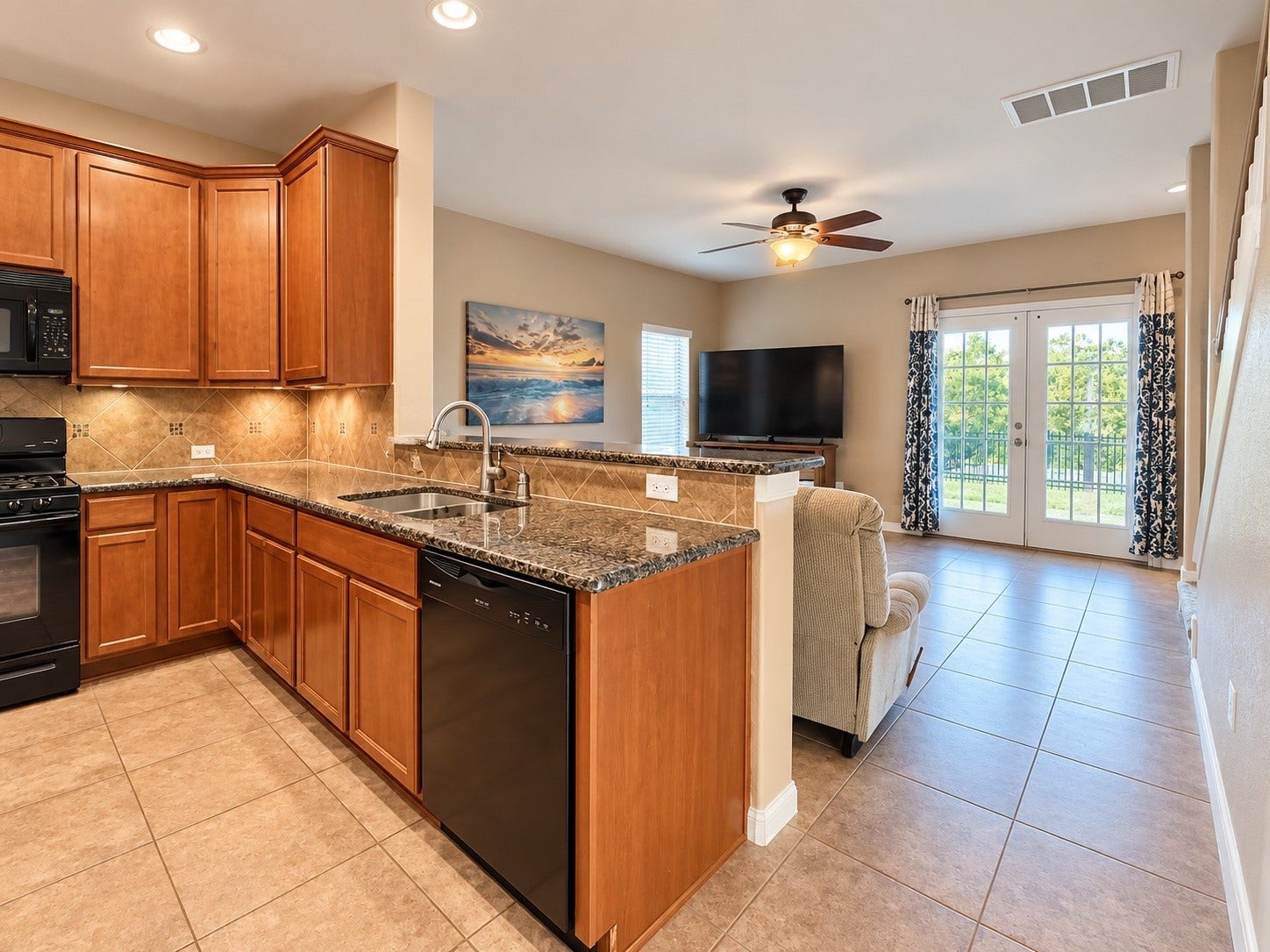 Open kitchen featuring a center island, breakfast bar, granite countertops, and plenty of cabinet space.