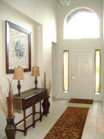 HIGH CEILING ENTRY WITH TILE ALL THE WAY TO BREAKFAST AREA.
