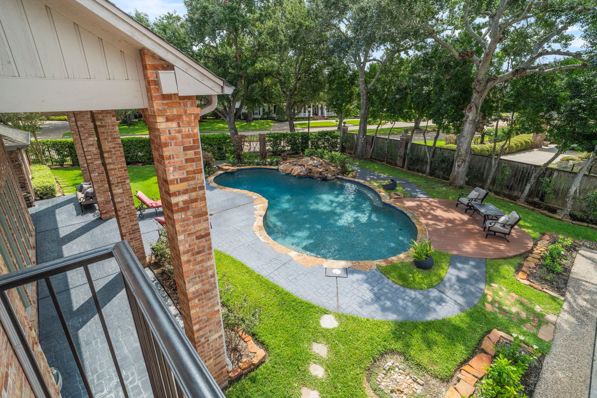A stunning lagoon pool with a waterfall feature and built-in seating transforms the backyard into a relaxing retreat.