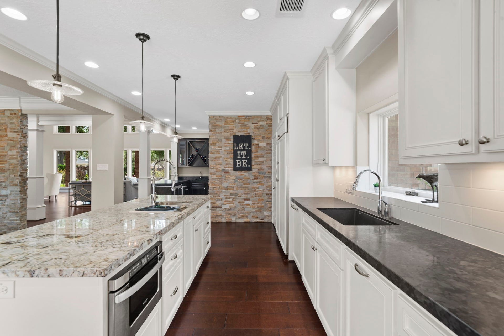 A thoughtfully designed lighting plan combines LED recessed daylight lighting, pendant lighting, and under-cabinet illumination.