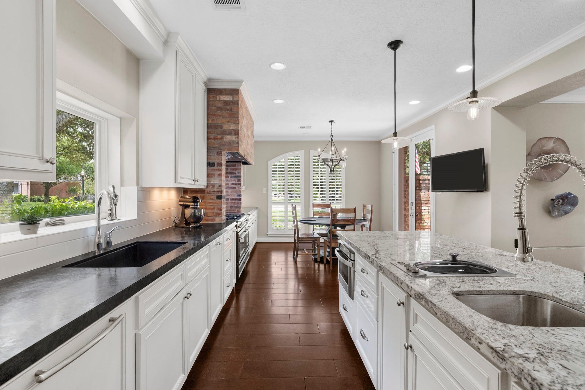 The kitchen is appointed with black leathered-finish quartz countertops, prized for their distinctive texture and low-maintenance durability.