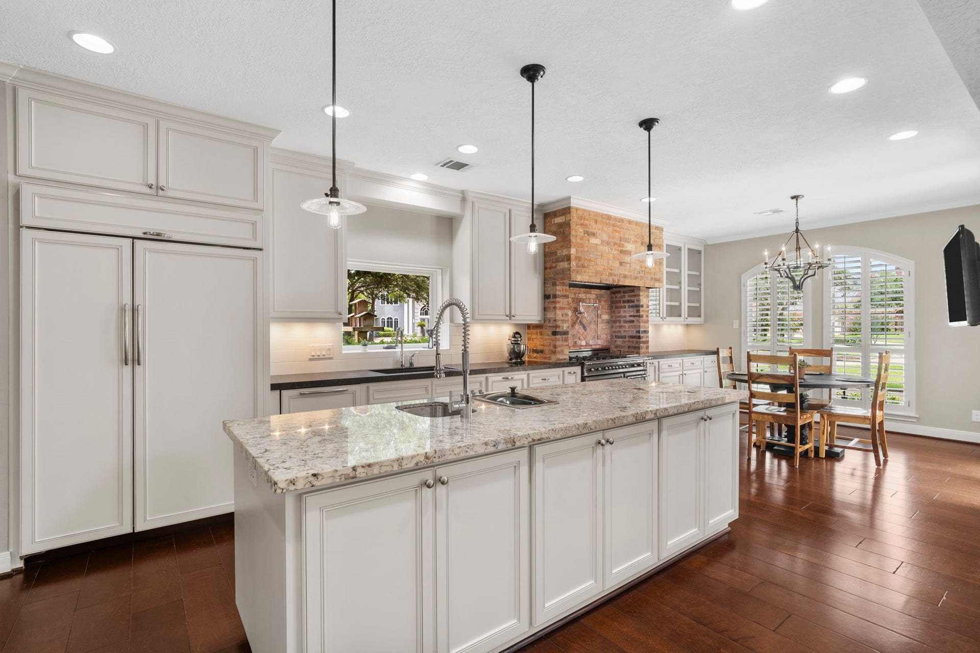 Designed for serious cooks, the chef's kitchen features an oversized island with a vegetable sink equipped with insinkerator, and built-in Gaggenau steamer.