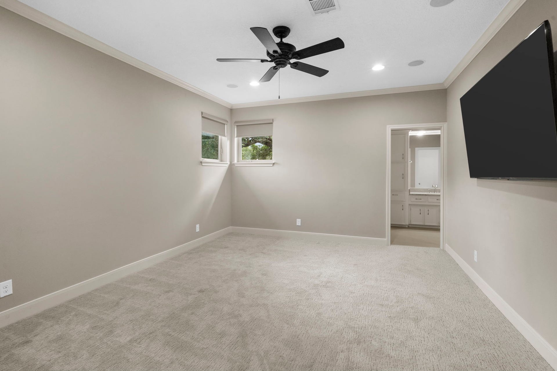 An upstairs escape, the media/5th bedroom features built-in speakers with surround sound, an en suite Hollywood-style bath, and a large walk-in closet with Elfa storage.