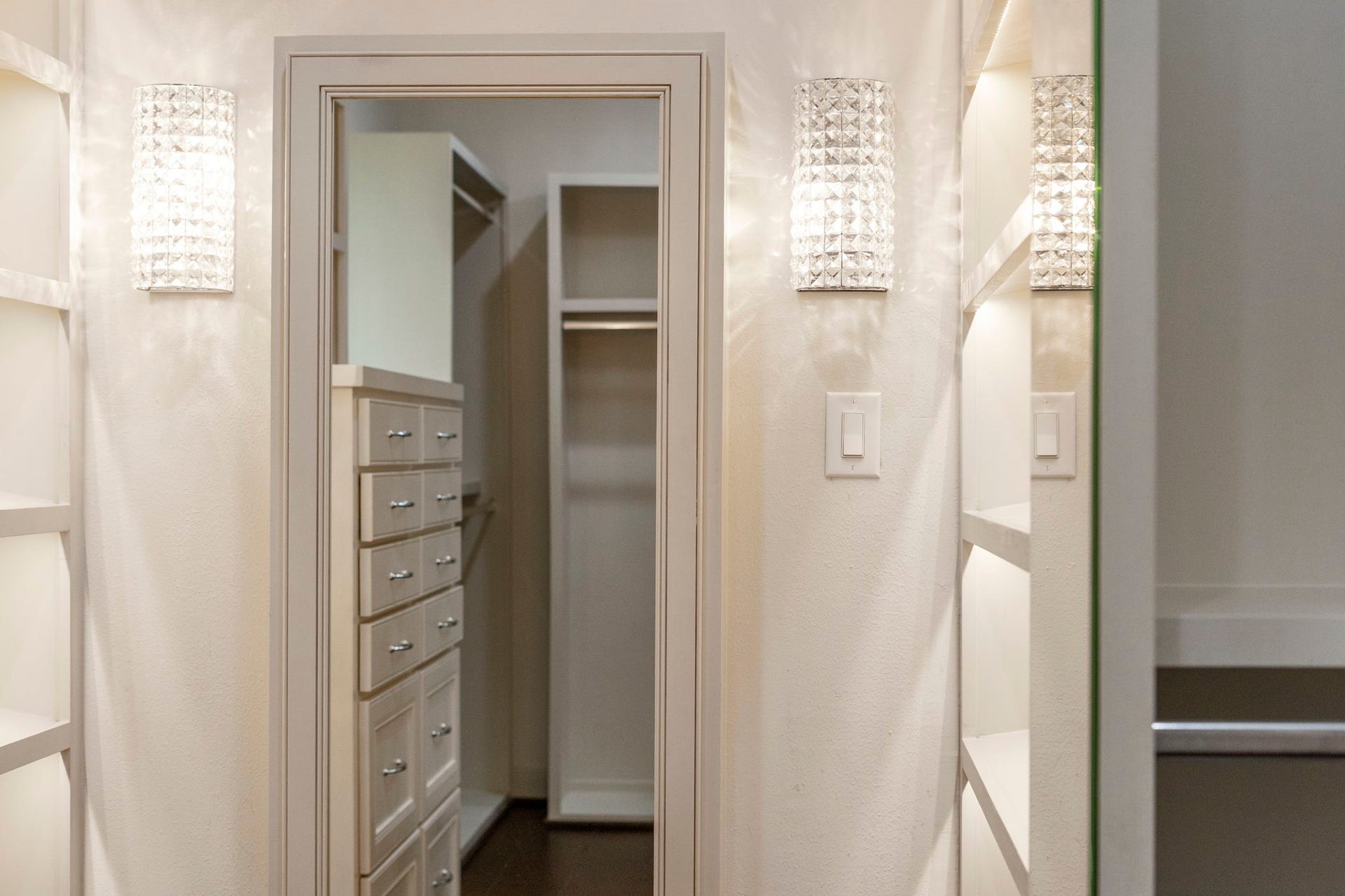 A dream dressing room awaits with custom cabinetry, beautiful lighting, and every detail thoughtfully designed for a refined wardrobe experience.