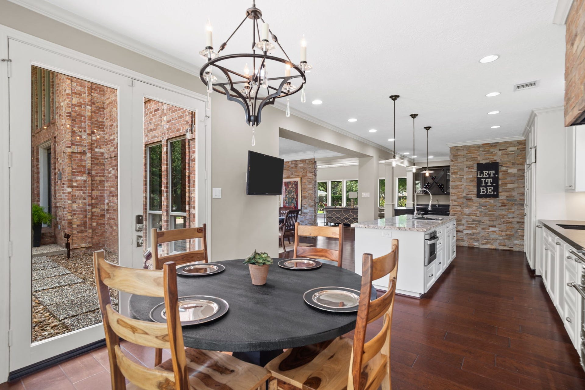 The breakfast area opens to a secluded walled patio, perfect for morning coffee or al fresco dining.