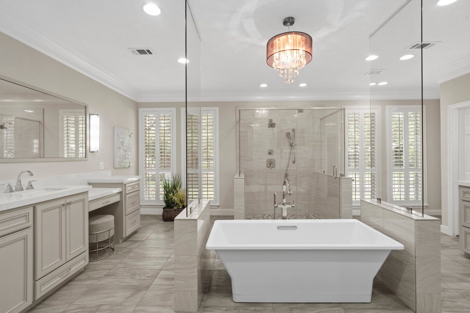 Expansive windows framed by plantation shutters bring in abundant natural light while maintaining a sense of privacy and elegance.
