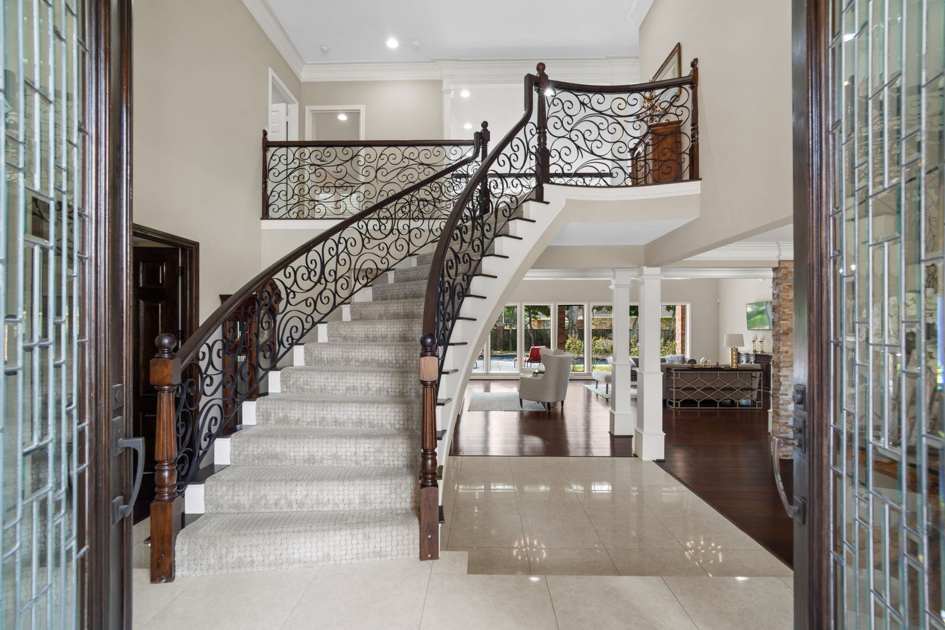 A floating staircase and soaring 30-foot ceilings define the home's impressive entry.