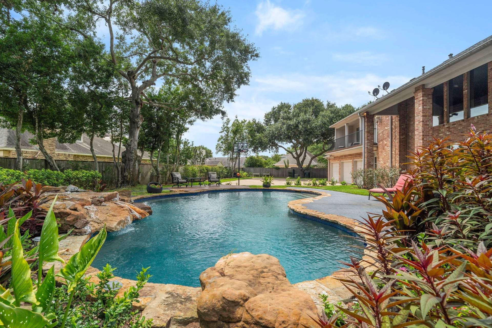 Resort-style private backyard retreat with sparkling pool, cascading waterfall and room to relax or entertain.