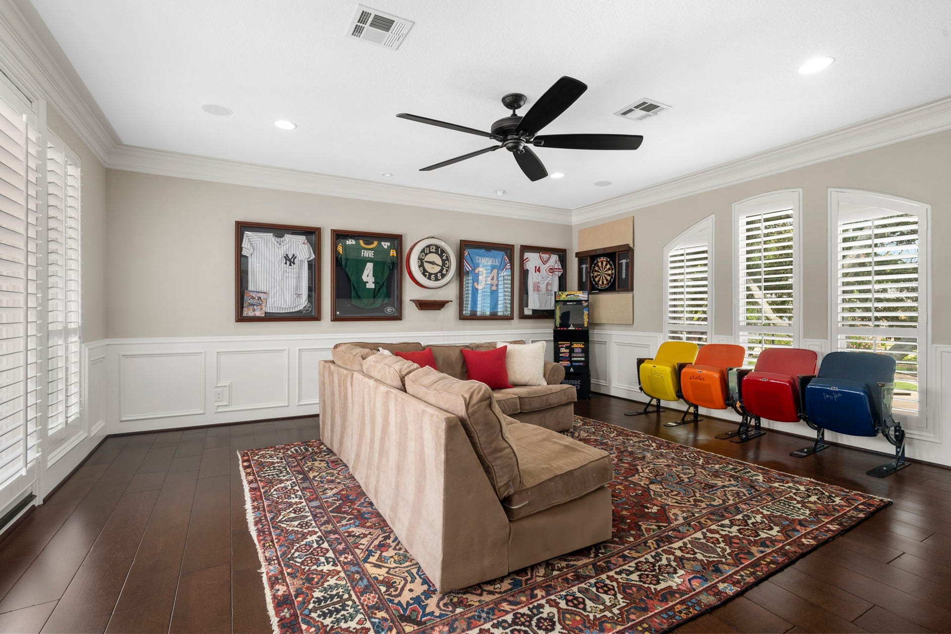 Surrounded by natural light, the game room offers a full bar and French doors leading to an expansive balcony overlooking the backyard.