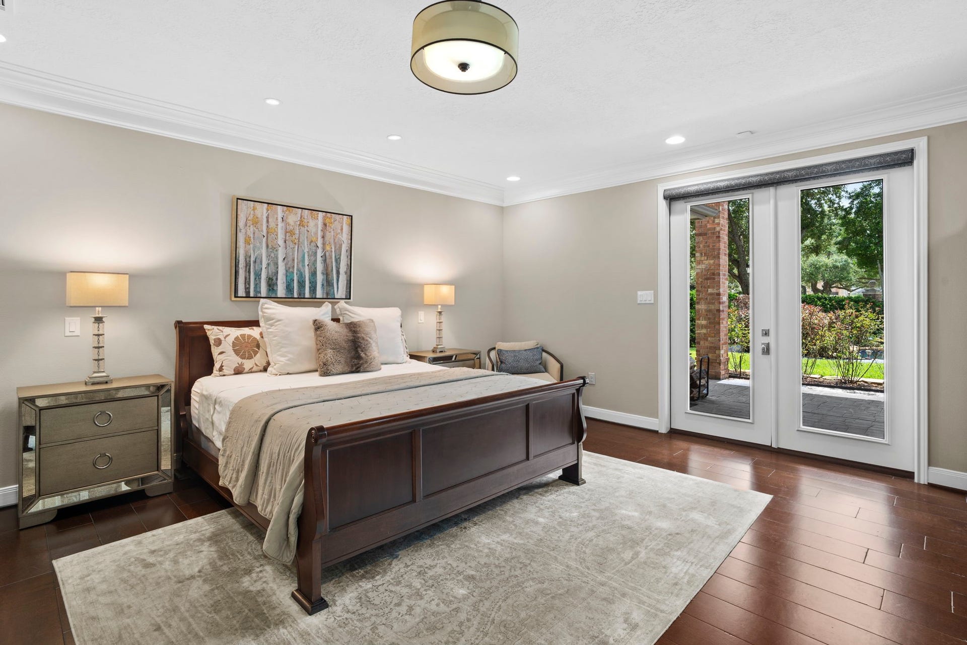 The first-floor owner's suite overlooks the pool and boasts an expansive spa-inspired bath with dual walk-in closets and dual private water closets.