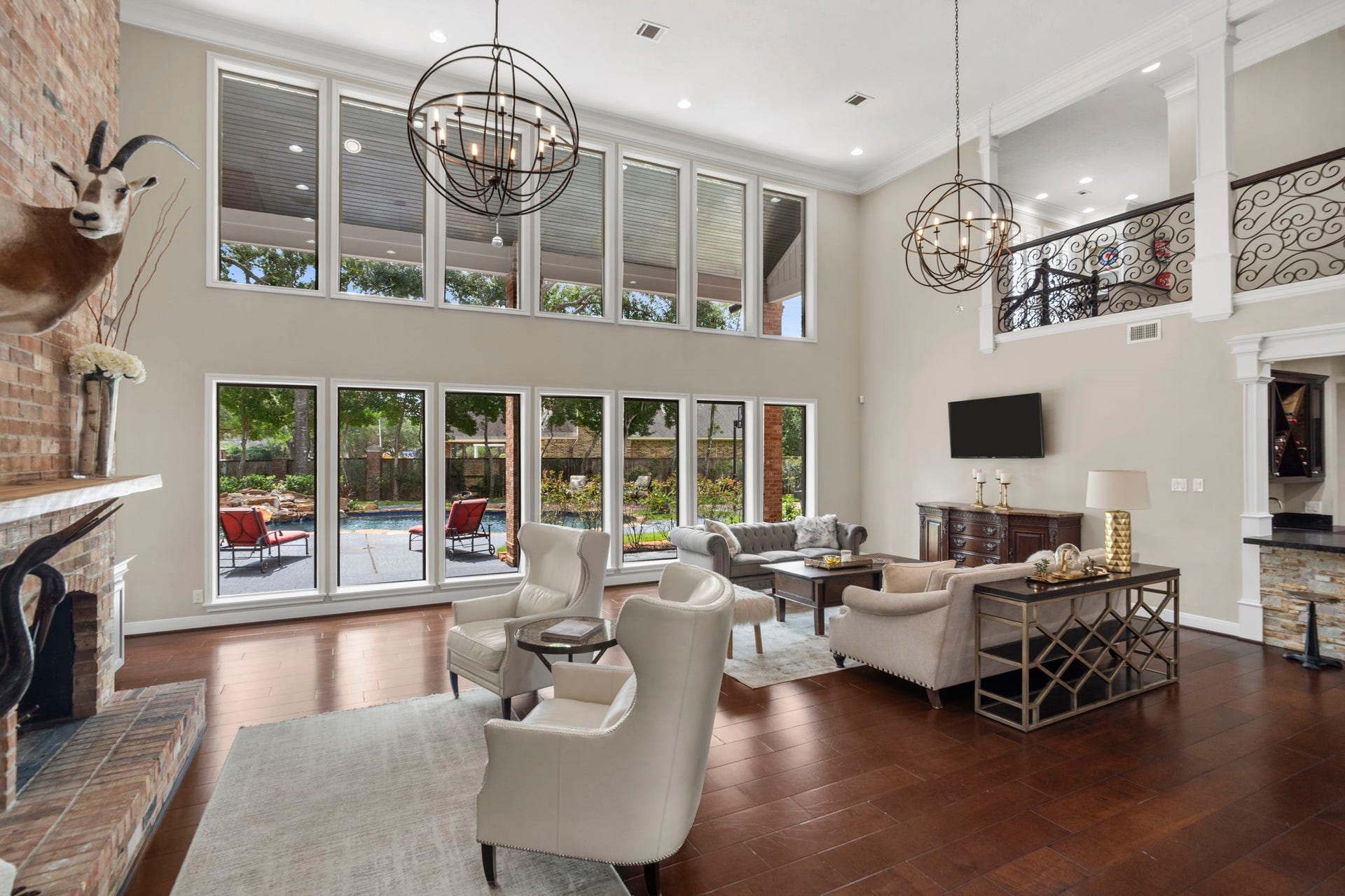 A grand two-story great room showcases impressive scale and timeless design. The wood flooring features rare plank-on-edge construction, using solid 2x8 lumber laid tightly side-by-side for exceptional strength, stability, and a solid feel underfoot.