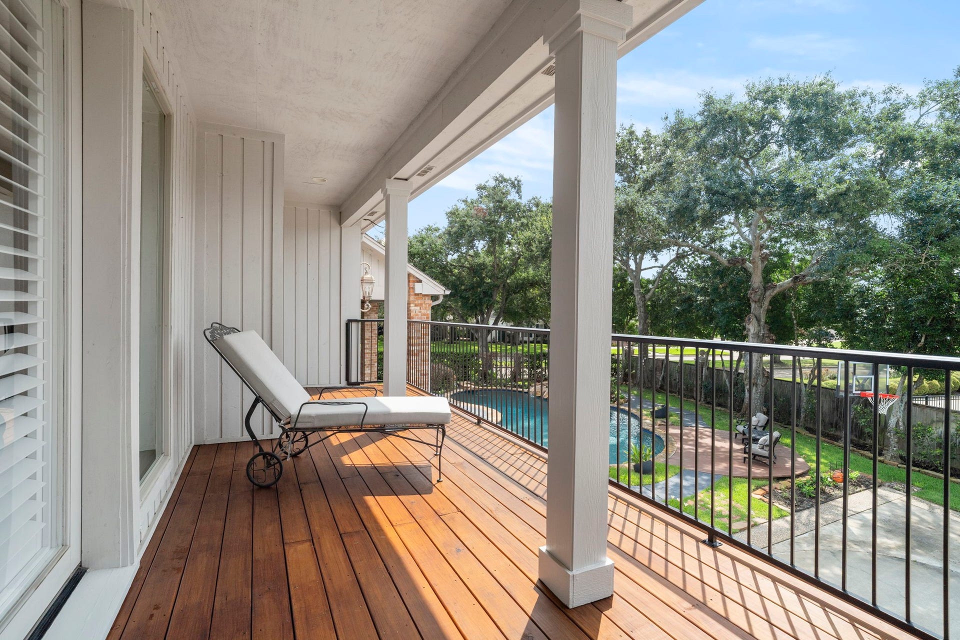 Enjoy a private vantage point overlooking the property, with panoramic views of the pool and motor/sports court below.