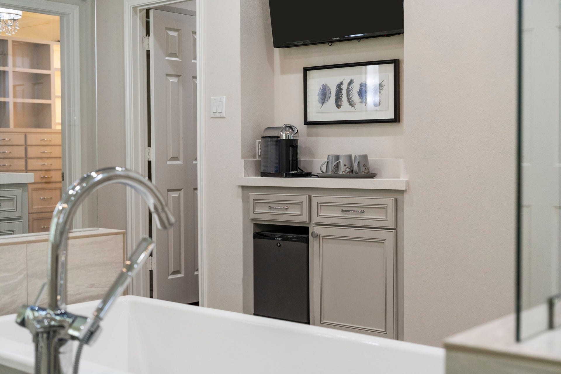 A private coffee bar with mini fridge and TV adds a touch of resort-style convenience.